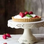 Strawberry custard tart on cake plate