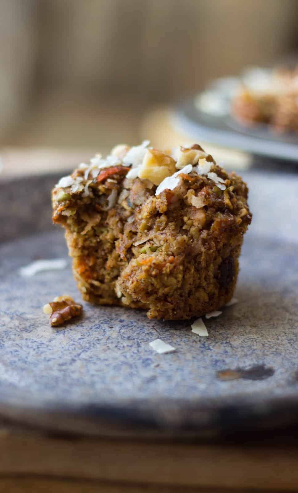 A healthy muffin recipe (morning glory) that has a bite taken out of it and shown from a side view. 