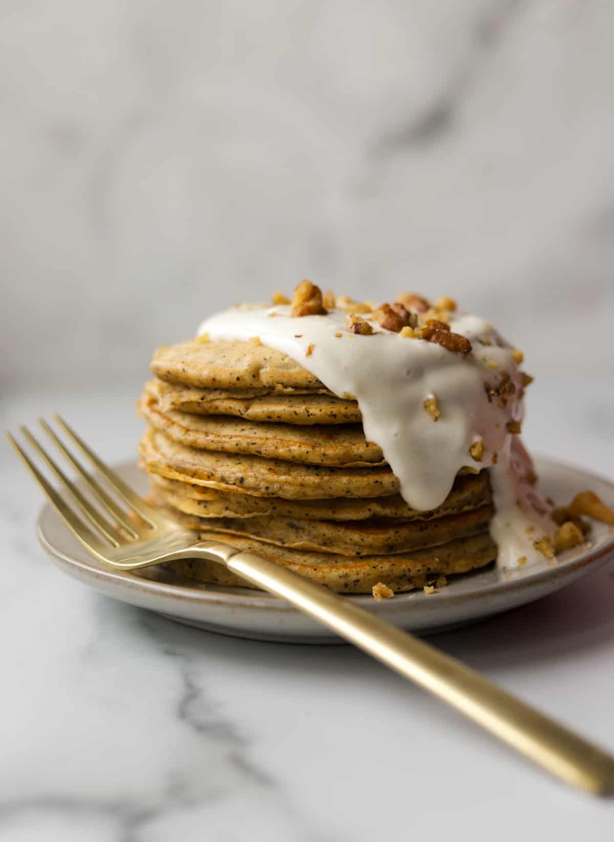 A side shot of a stack of walnut chai pancakes.