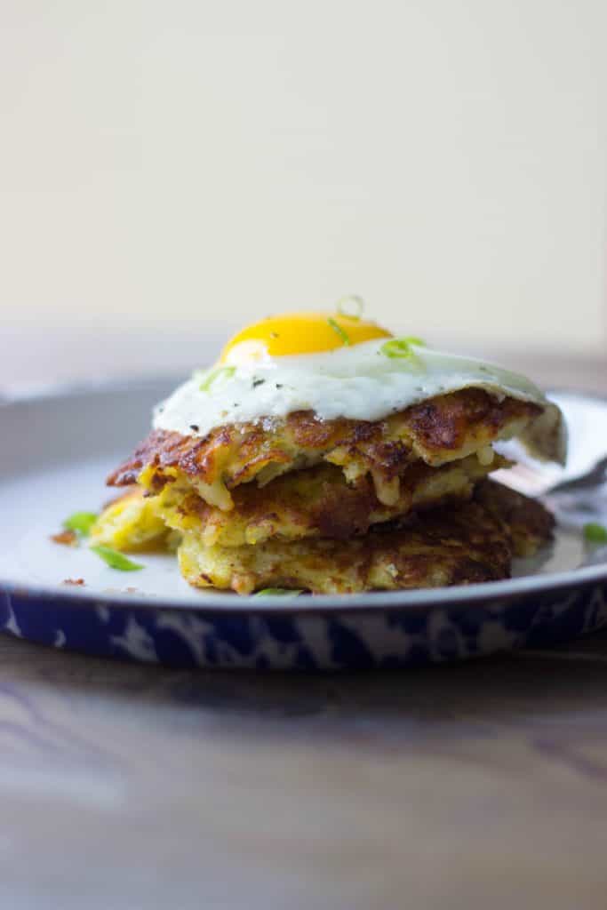 Hash brown haystacks with a fried egg on a white plate
