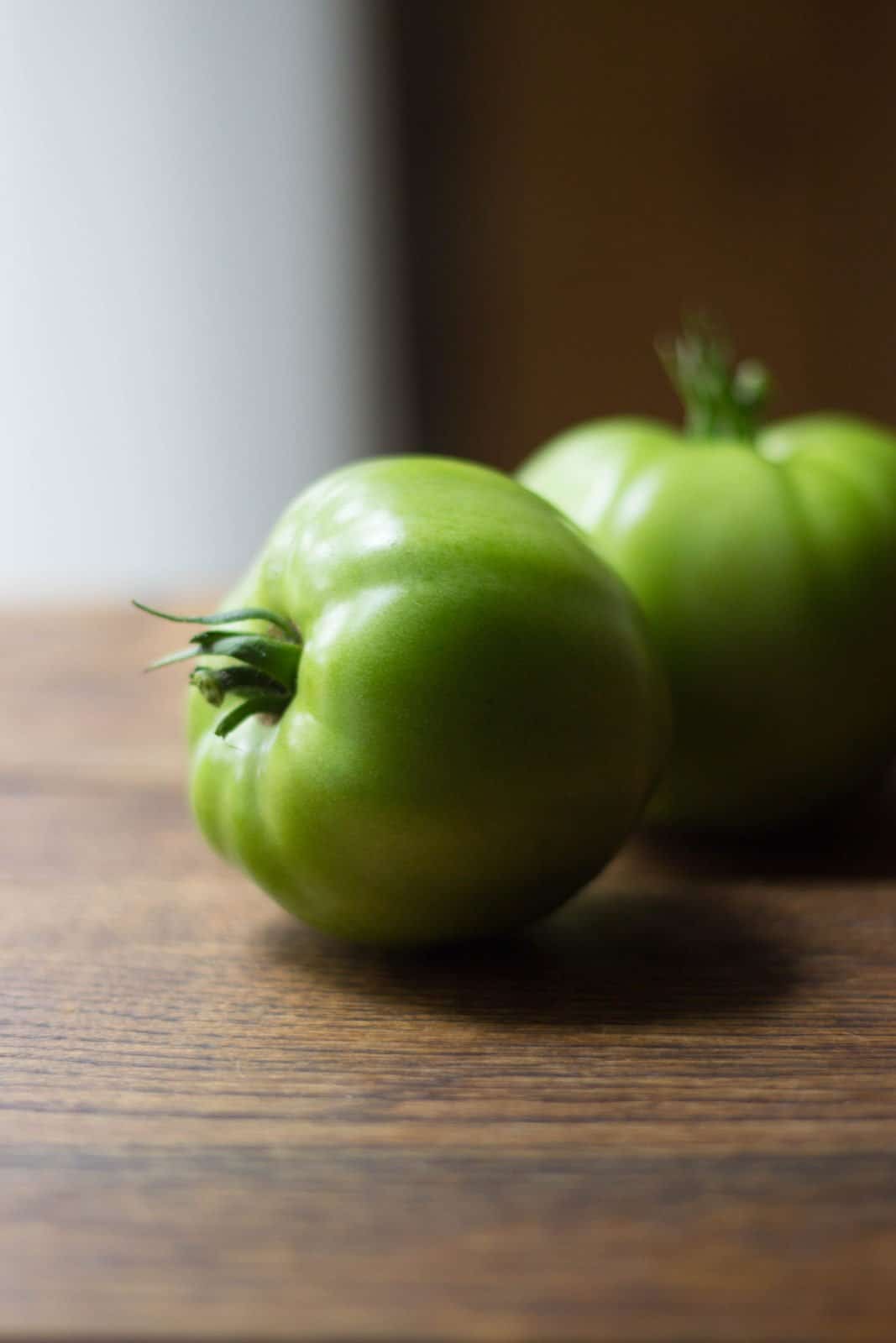 Green tomatoes on a board
