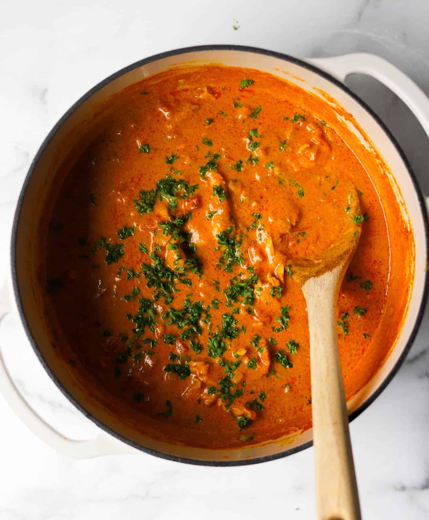Indian butter chicken in a white pot