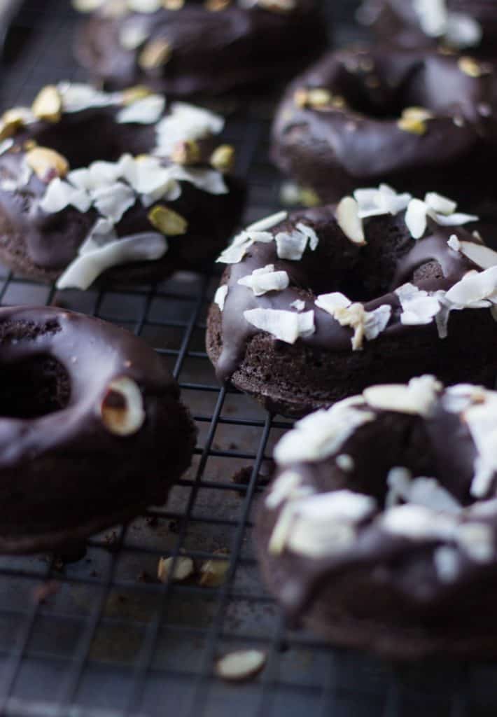 Dark chocolate glazed donuts on a rack