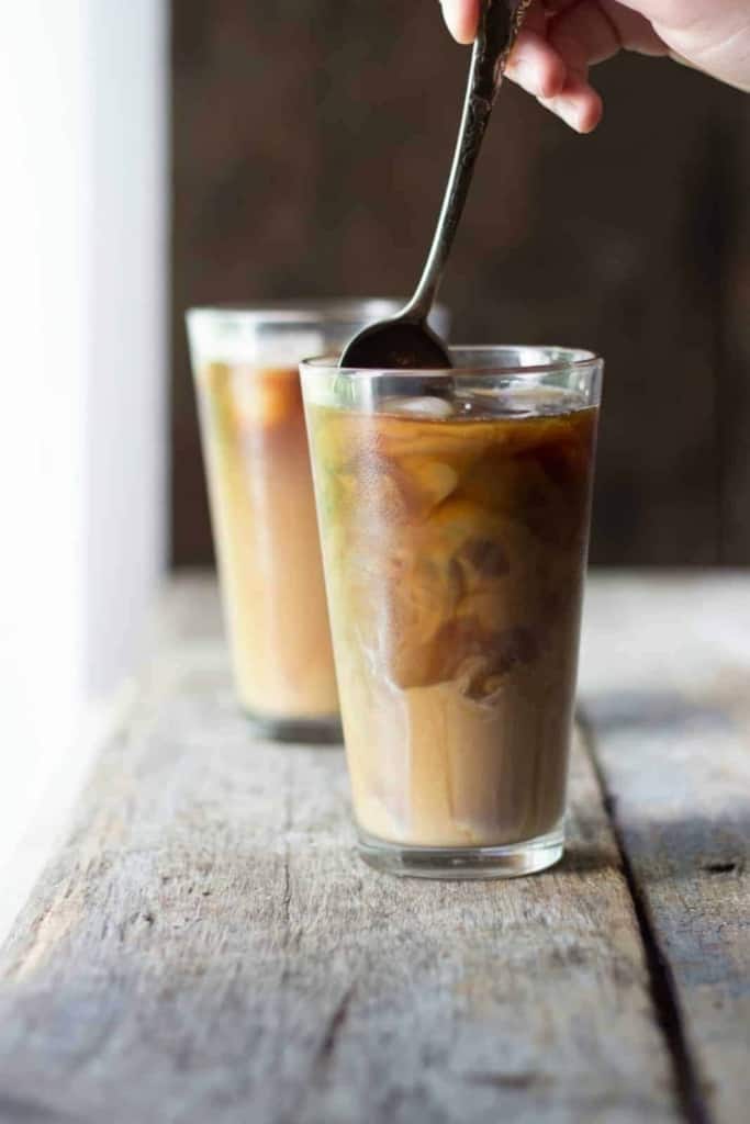 Side shot of dulce de leche iced american in a glass cup