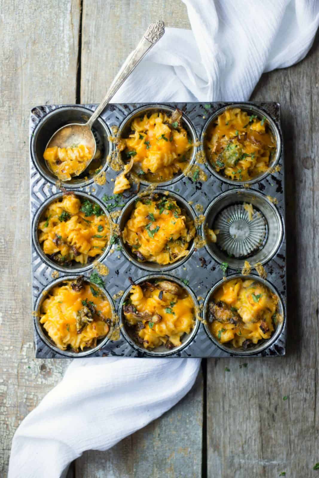 A healthy back-to-school recipe of veggie mac and cheese cups in a muffin tin. 