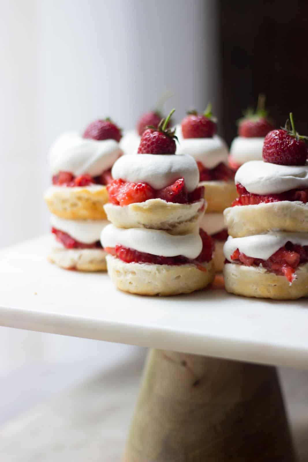 Close up shot of mini strawberry shortcake stacks on a cake stand