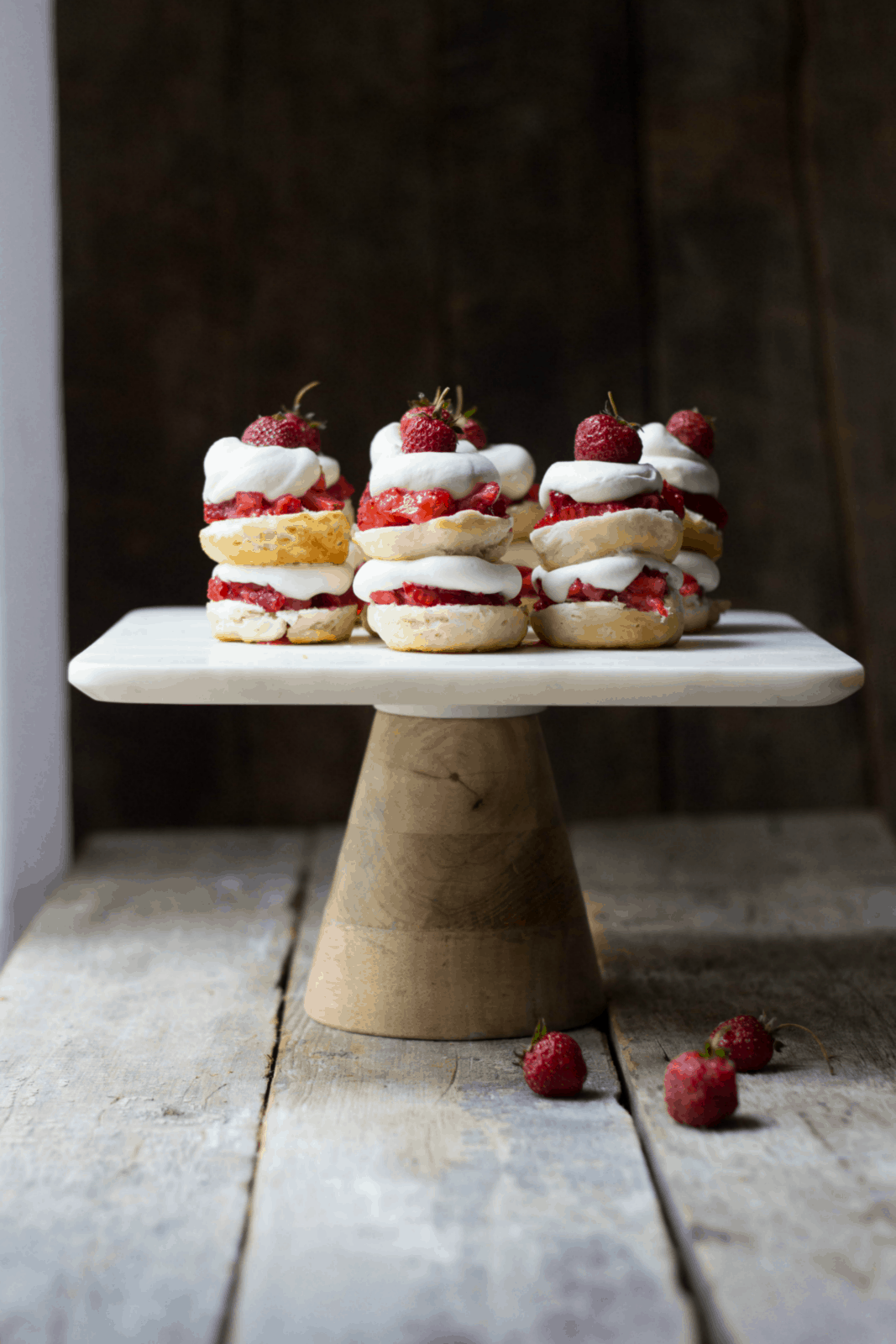 Mini strawberry shortcake stacks on a cake stand