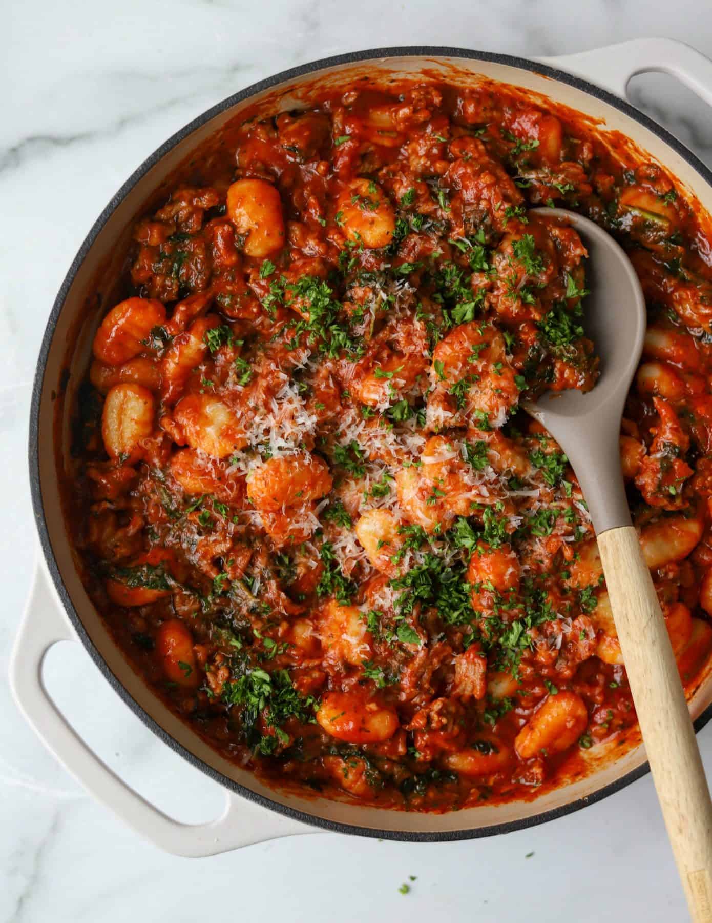 Italian Sausage, Kale & Gnocchi Skillet in a white pot as a simple weeknight dinner option to make cooking easier.