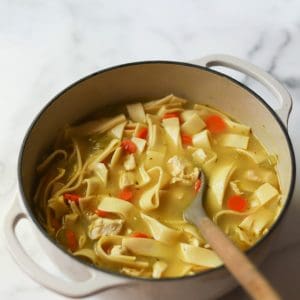 Chicken noodle soup in a pot.