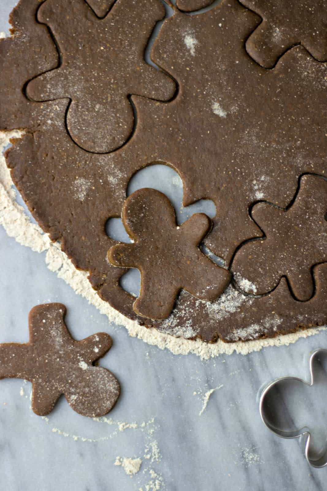 Overhead shot of gingerbread man cut-out from flat dough. 