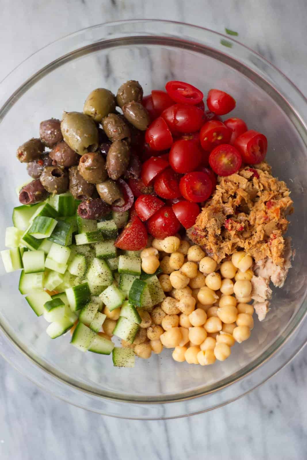 Mediterranean salad in a clear bowl.