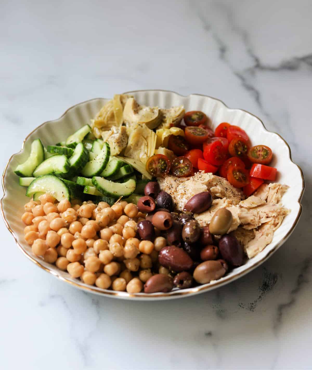A side shot of a bowl of Mediterranean chickpea salad.