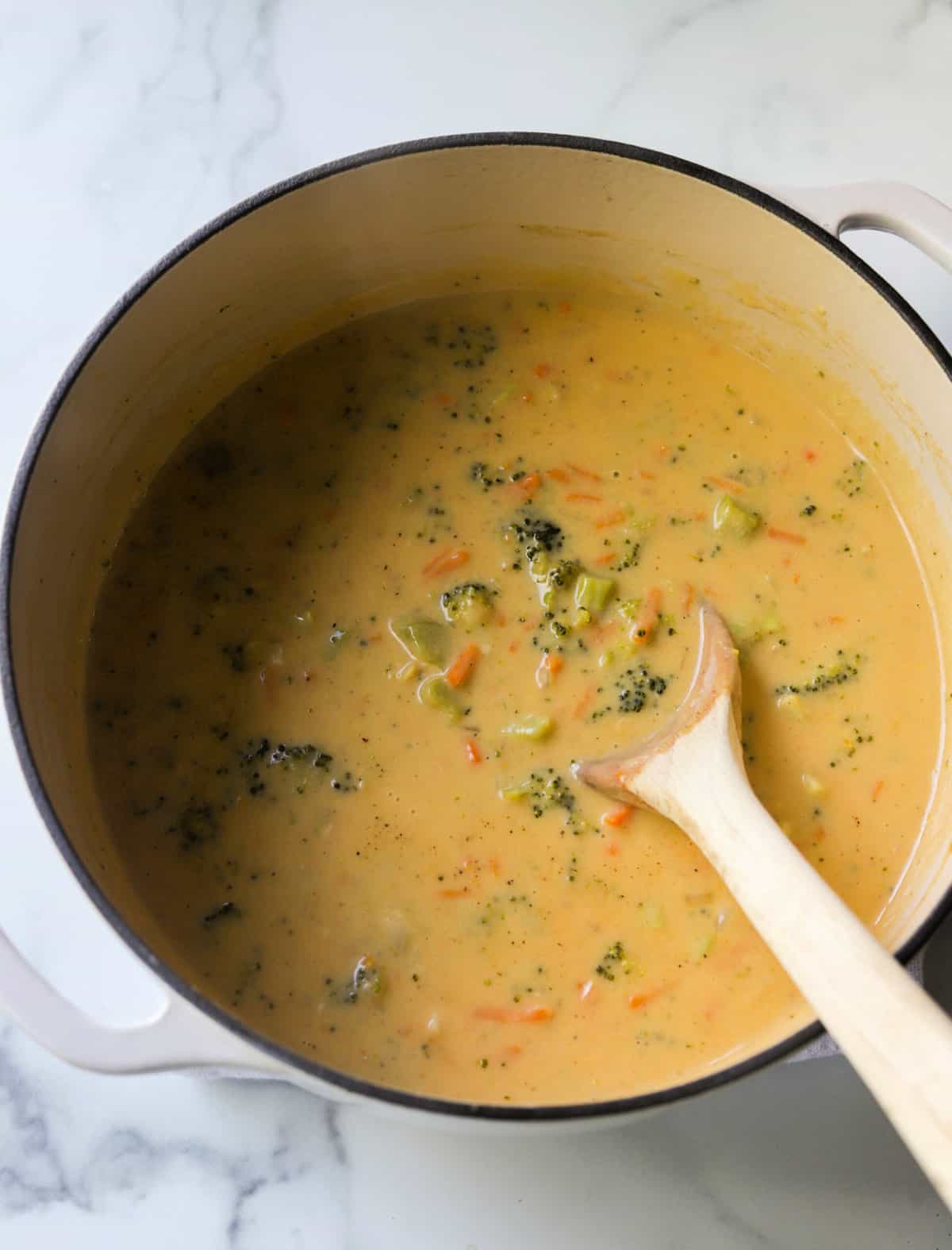 An overhead shot of a pot of broccoli cheese soup.