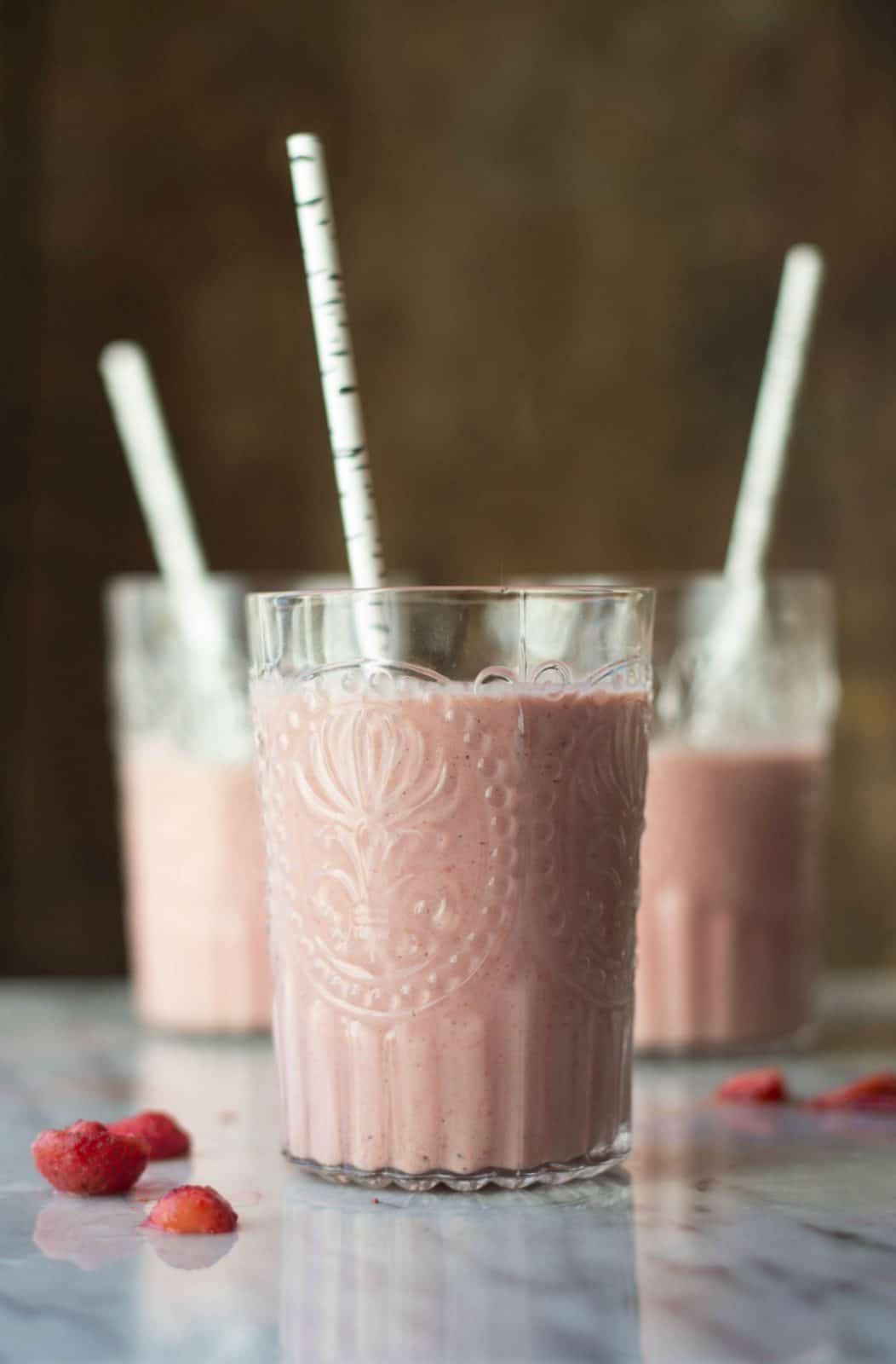 A side shot of a strawberry cashew smoothie.