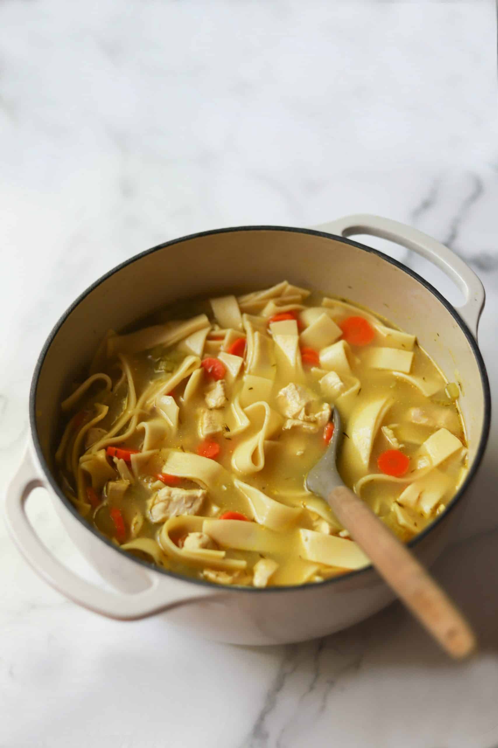 Chicken noodle soup in a white pot