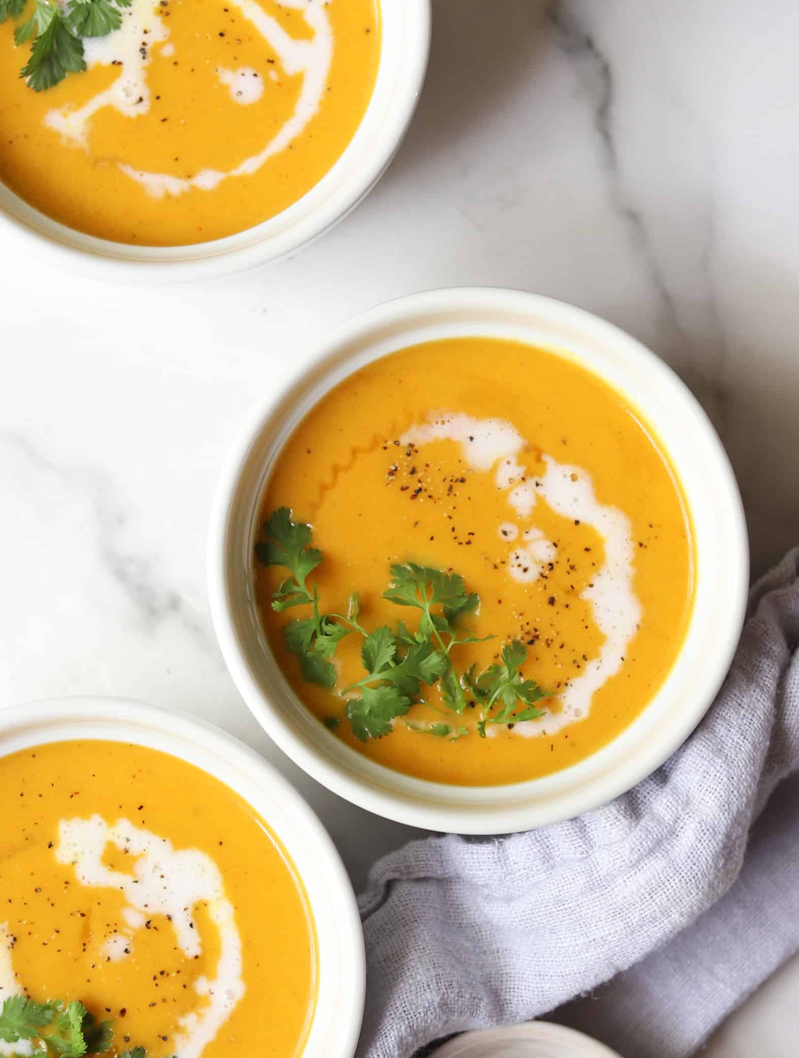 Three bowls of cauliflower coconut curry soup