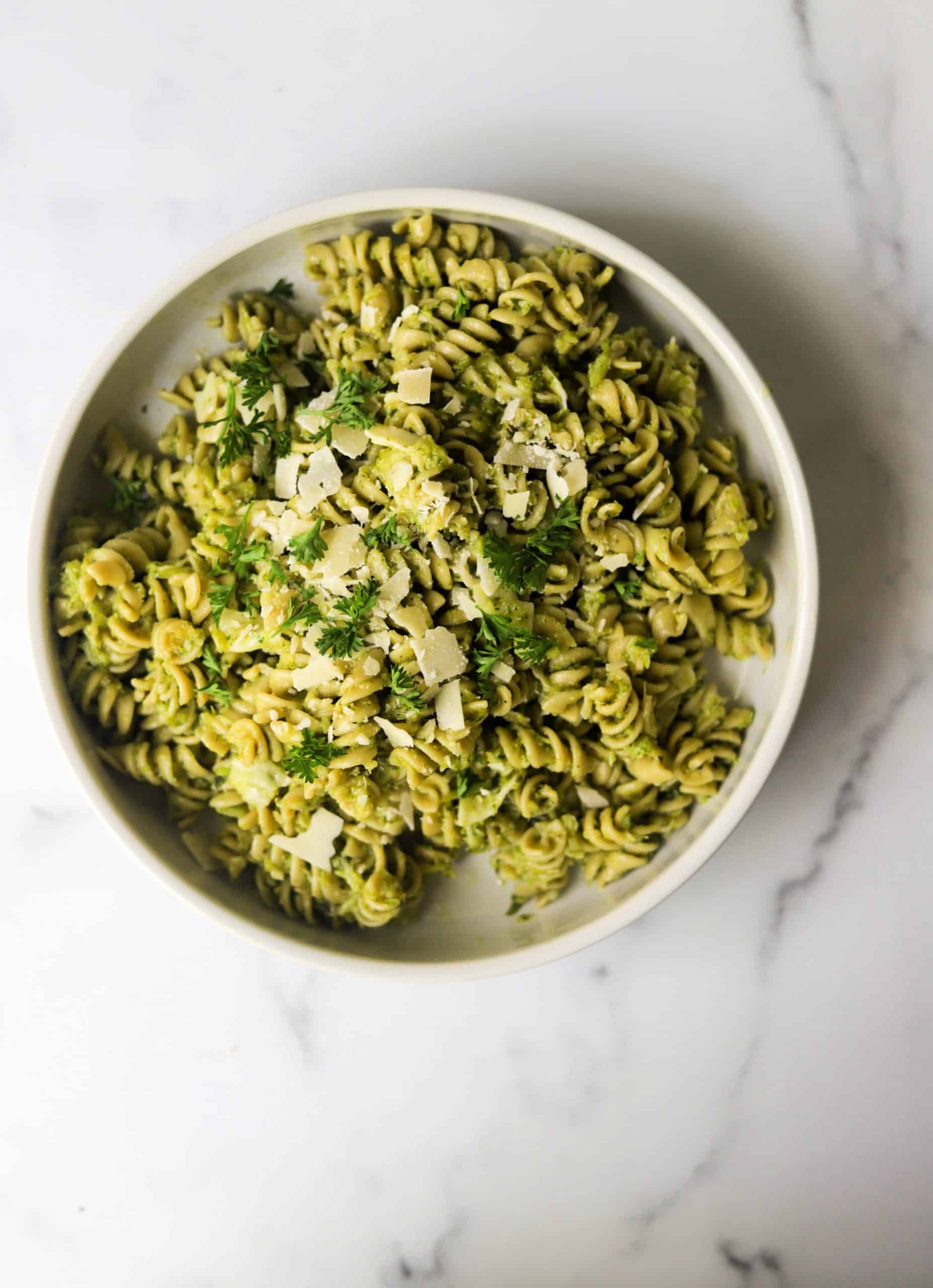 A white bowl filled with broccol pesto.
