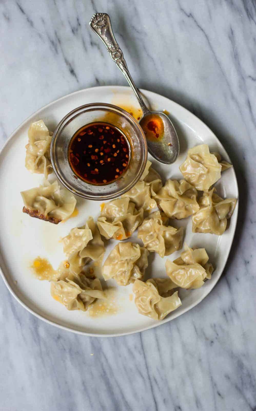 Full plate of Chinese Pork Dumplings with Chili Oil Dipping Sauce
