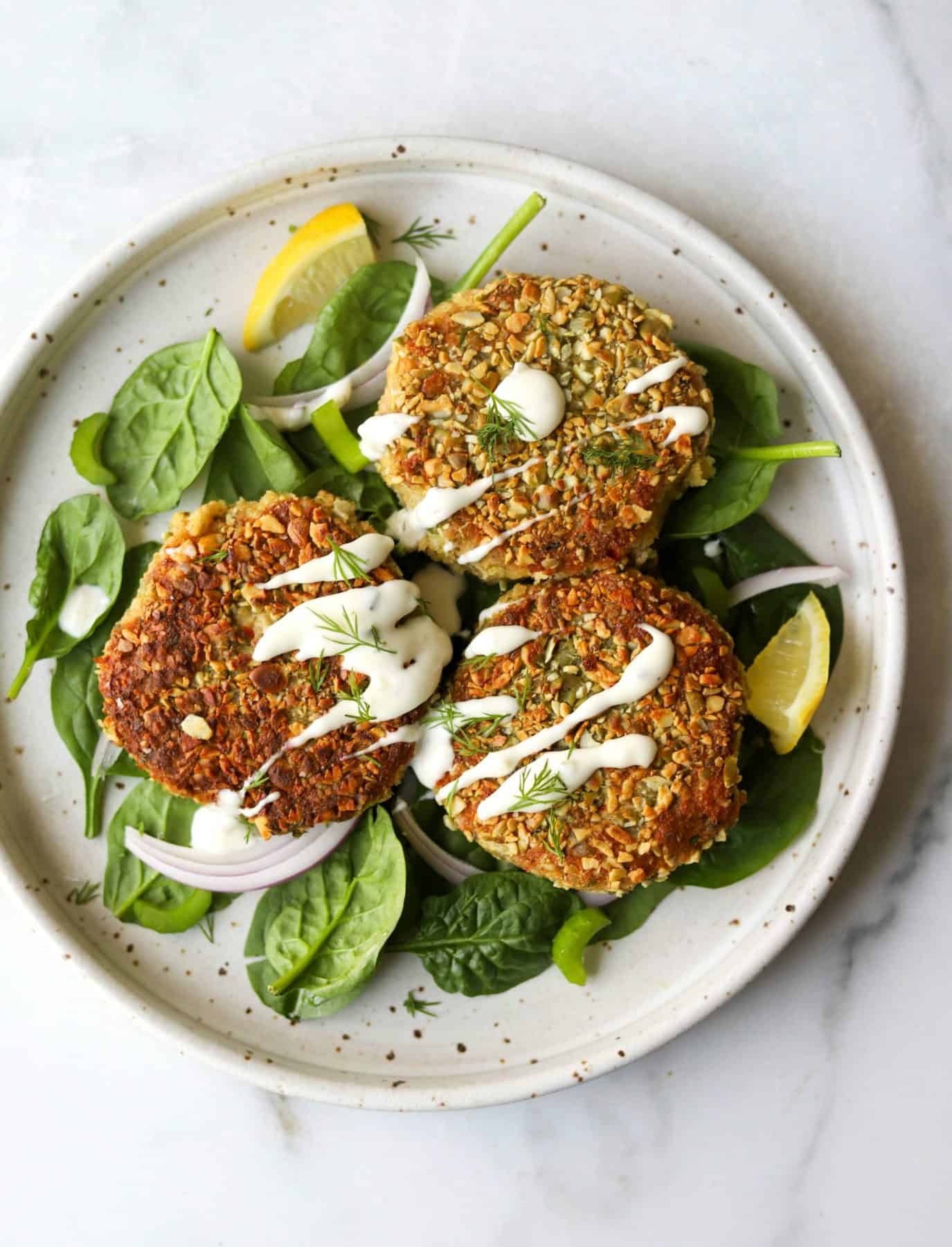 Tuna cakes on top of spinach (a leafy green)