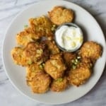 Artichoke & Goat Cheese Fritters in a white plate.