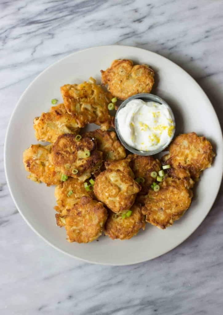 Artichoke & Goat Cheese Fritters on a white plate.