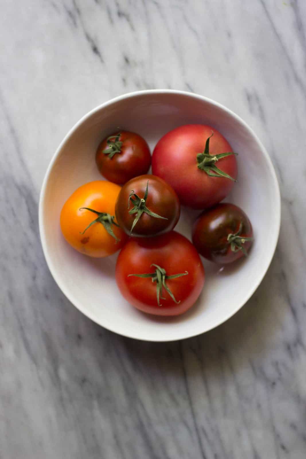 Heirloom Tomatoes on a marble board.