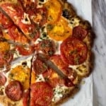 Rustic Heirloom Tomato Pizza on marble board.