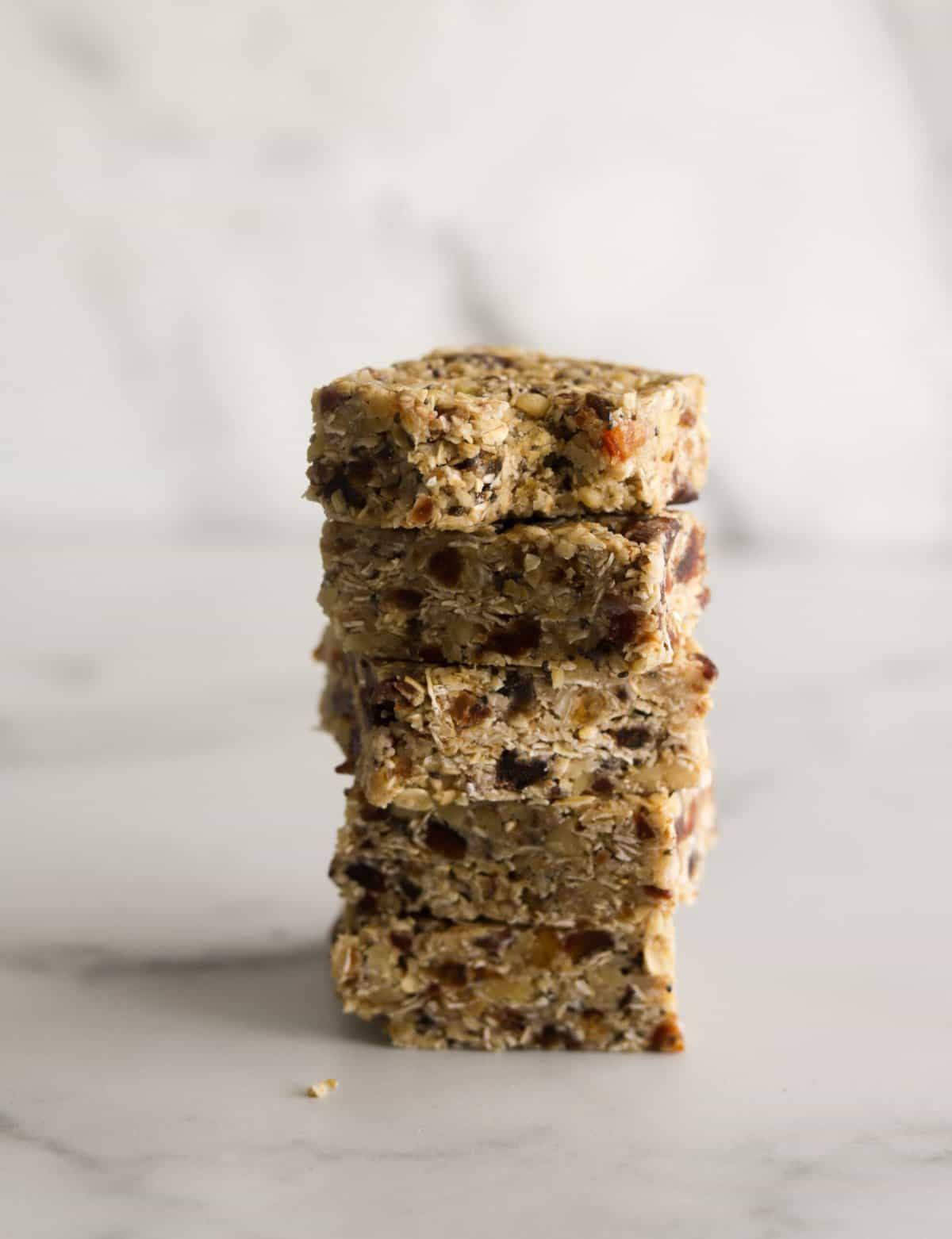 A side shot of stacked walnut oat bars with dates.