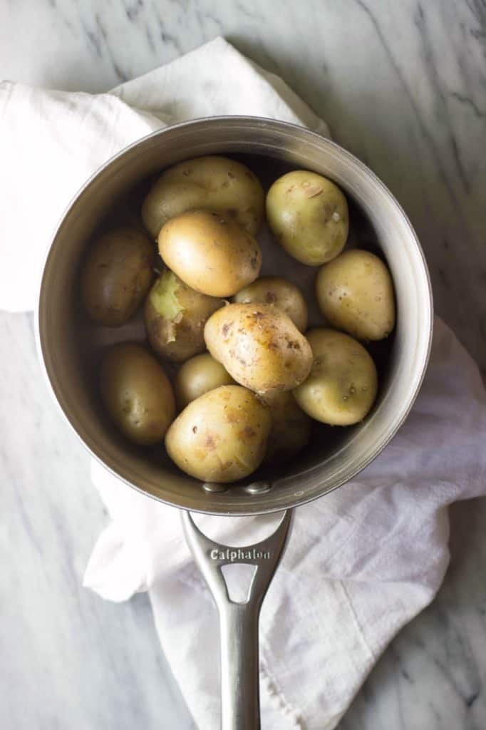 Cooked potatoes in a saucepan.