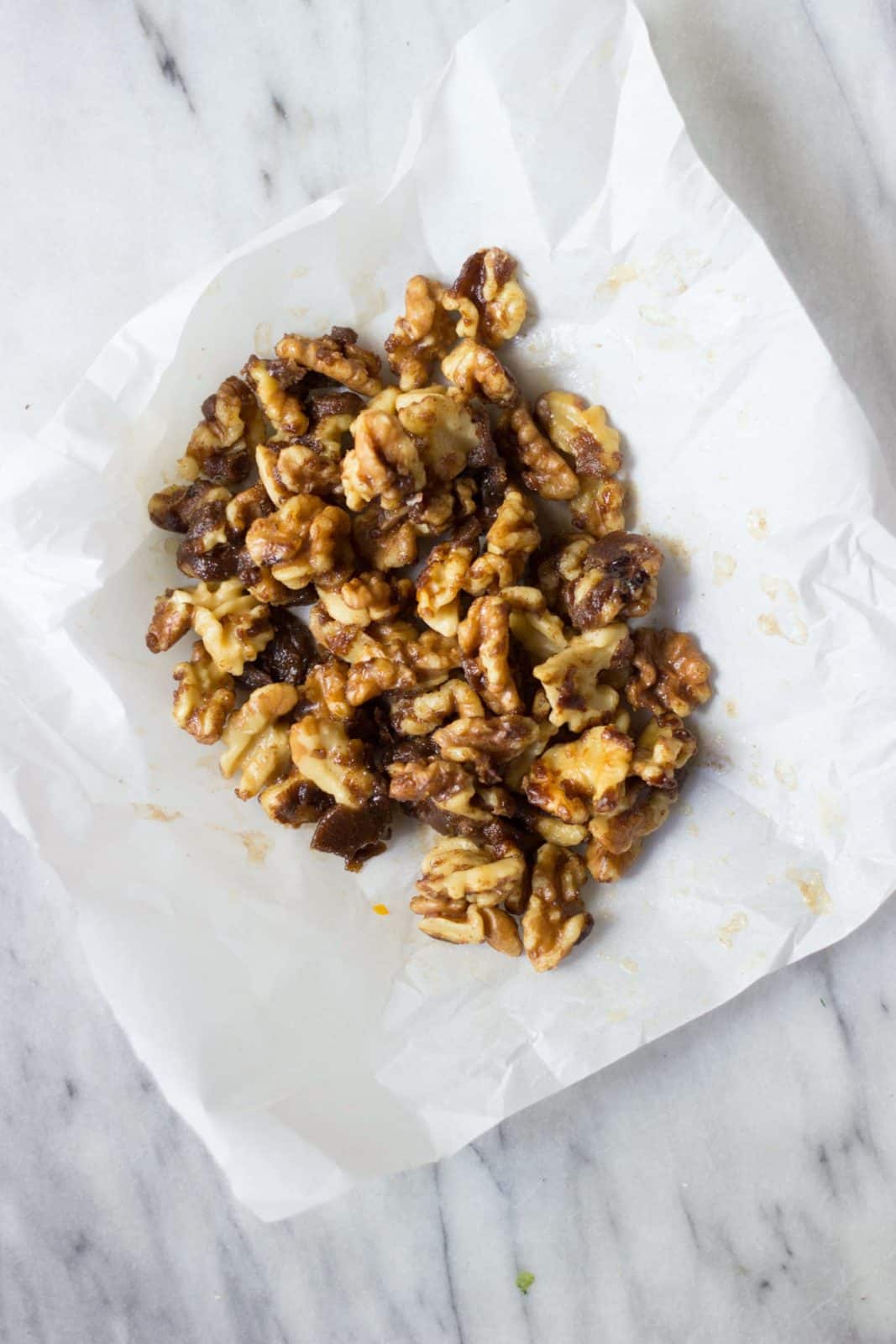 Candied walnuts on a marble board.