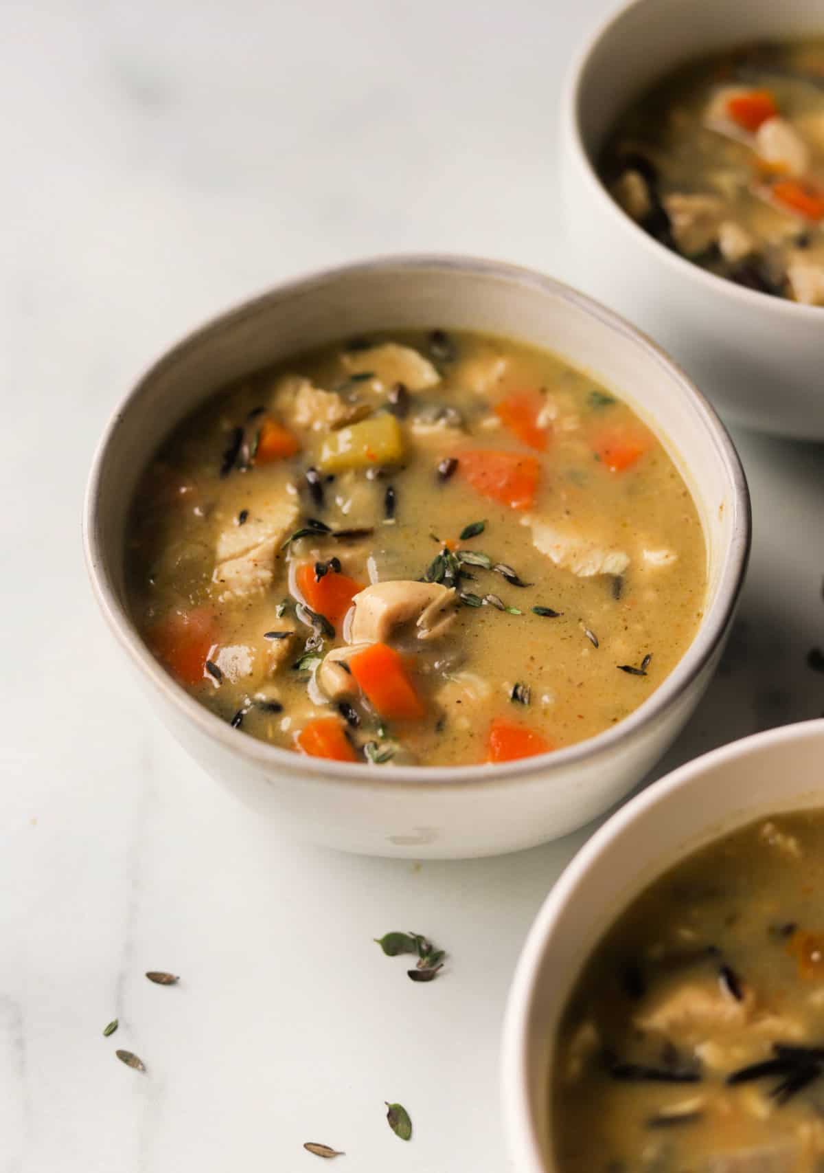 A front shot of bowls of chicken wild rice soup.
