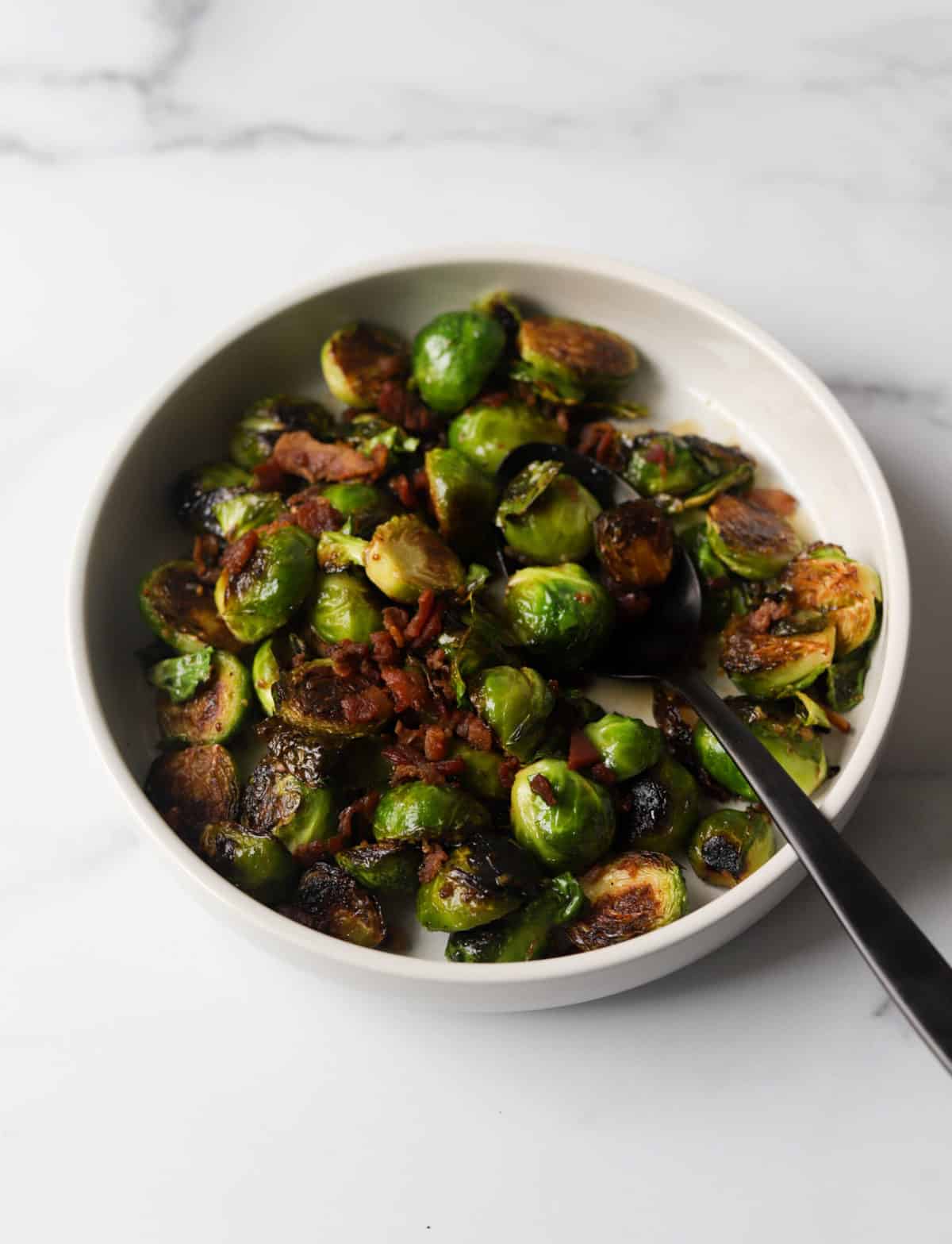 A side shot of a bowl of maple mustard brussels sprouts.