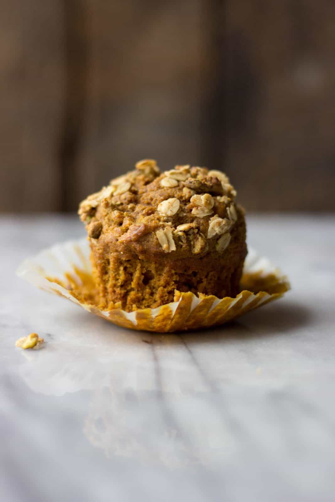 Pumpkin Muffin with Pistachio Crumble on marble.