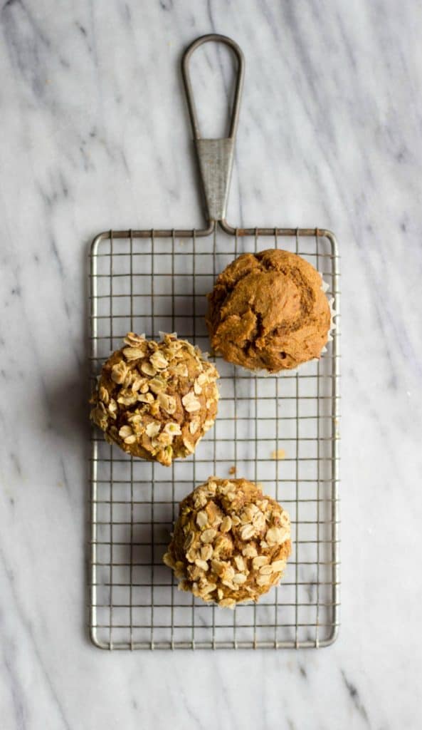 Pumpkin Muffin with Pistachio Crumble on marble.