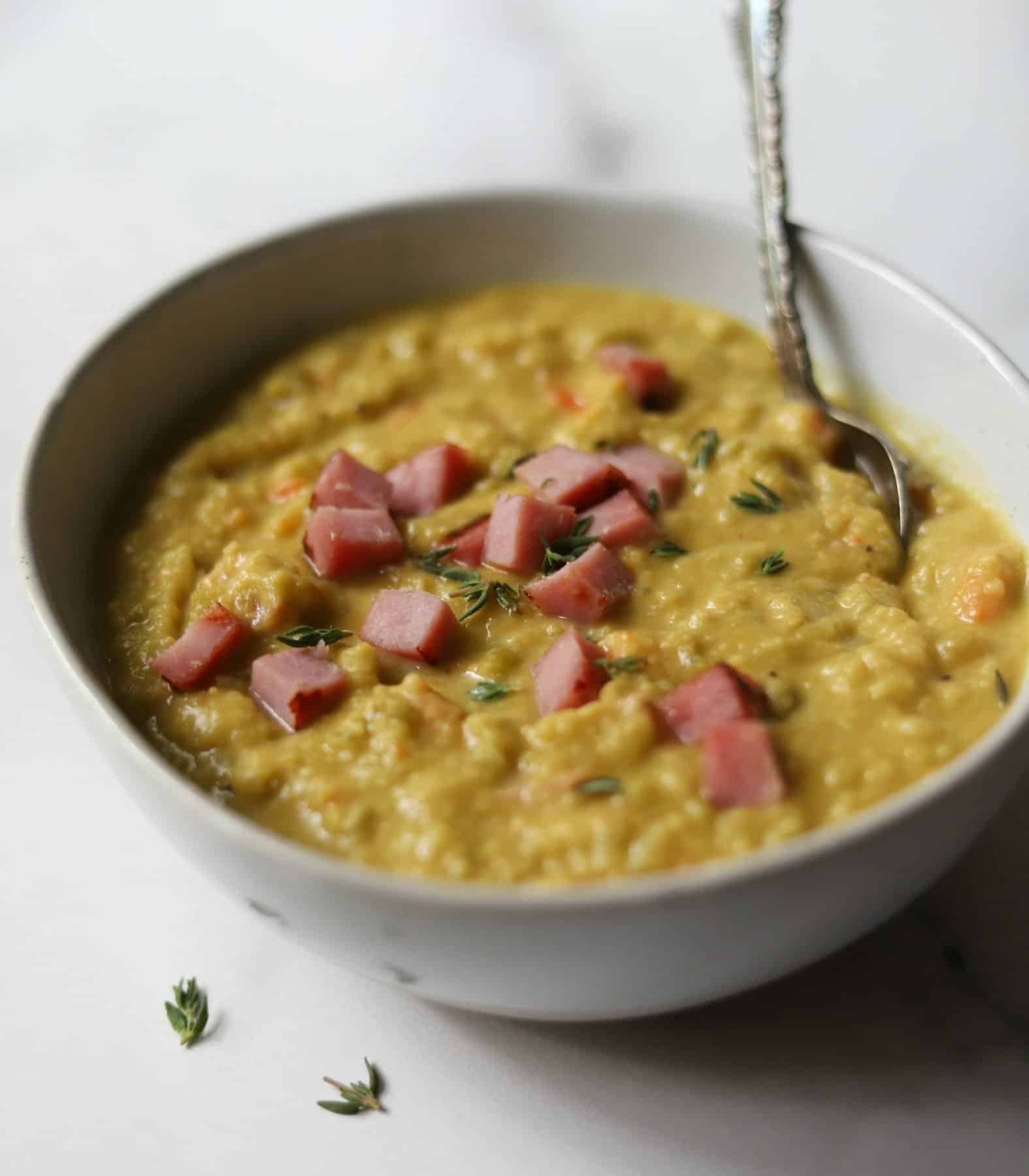 Split pea with ham soup in white bowl