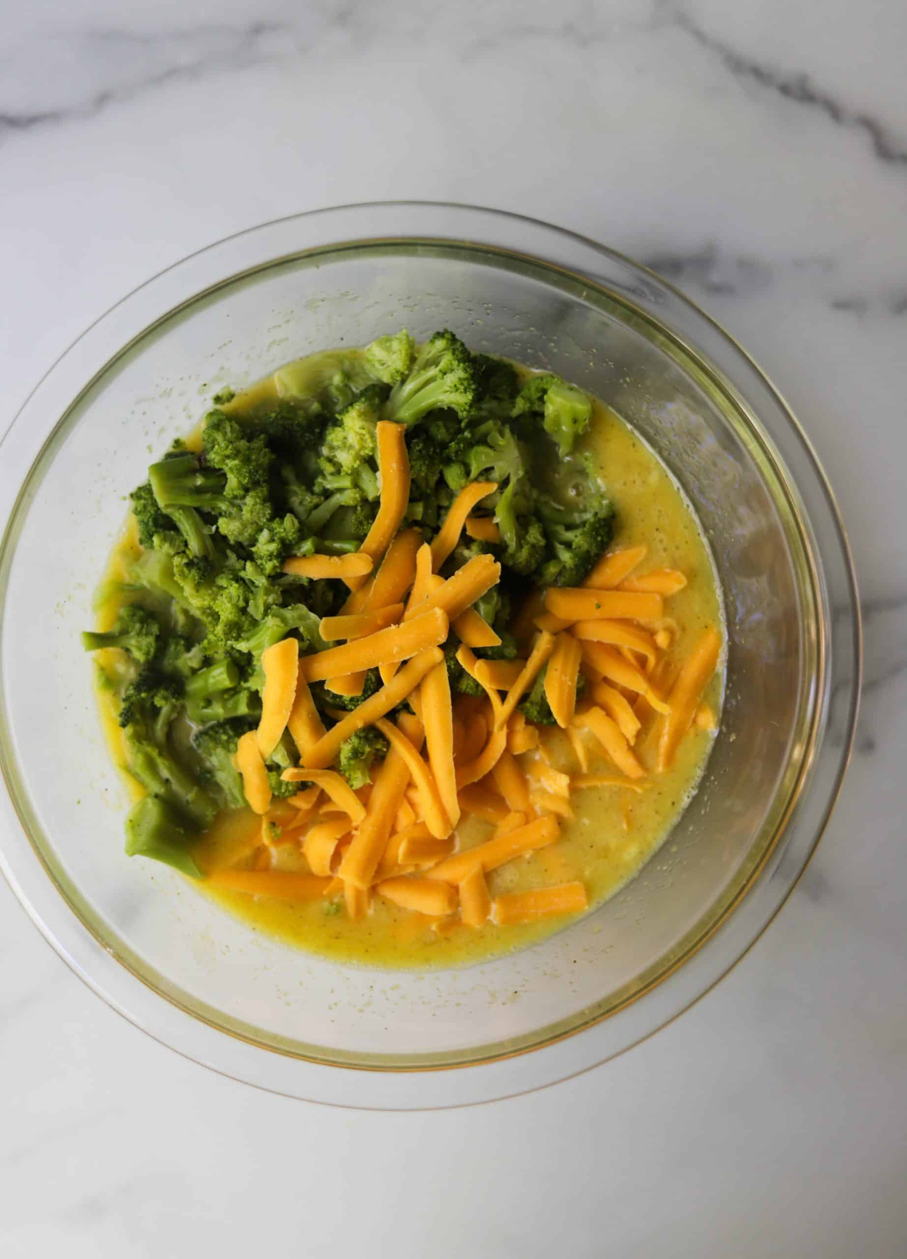 A bowl of egg mixture with broccoli.