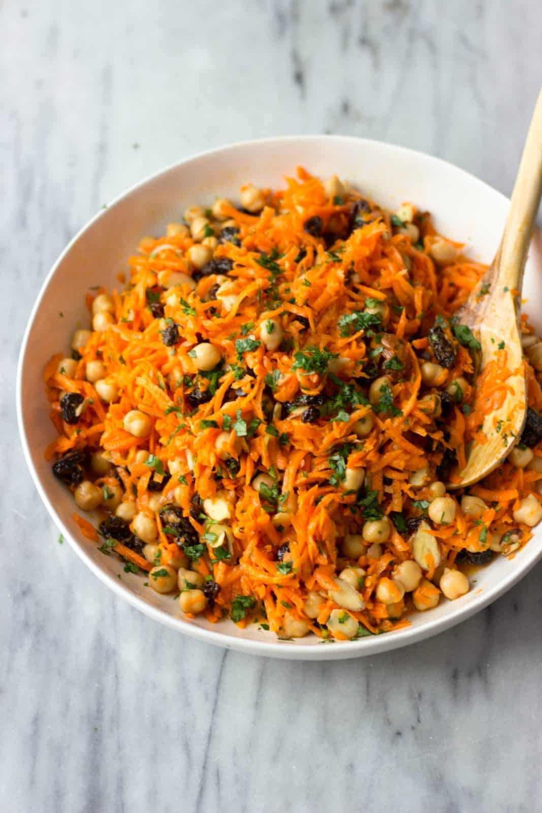 Finished Carrot, Chickpea & Raisin Salad in a white serving bowl