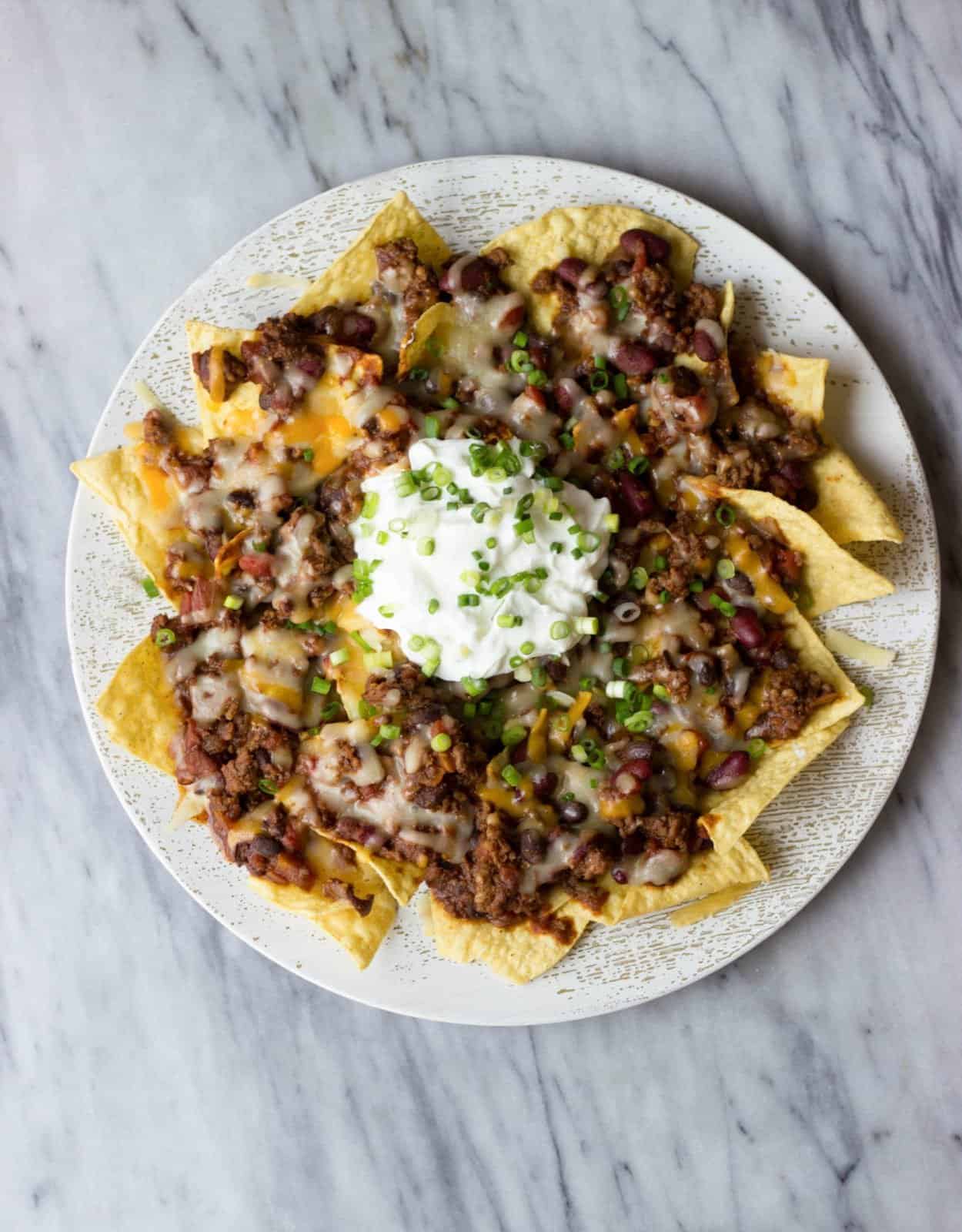 Overhead shot of Chili Nachos on a white plate