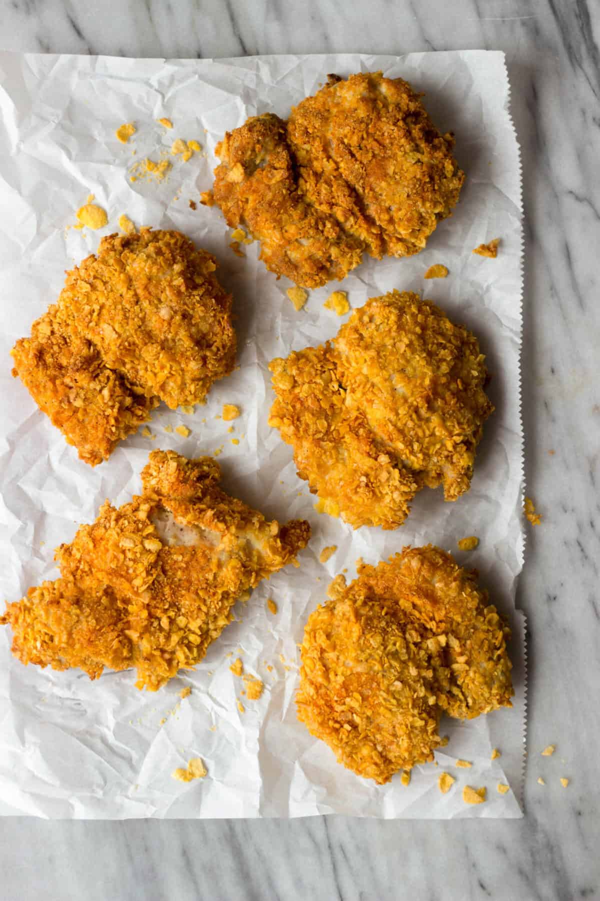 An overhead shot of cornflake crusted chicken thighs.