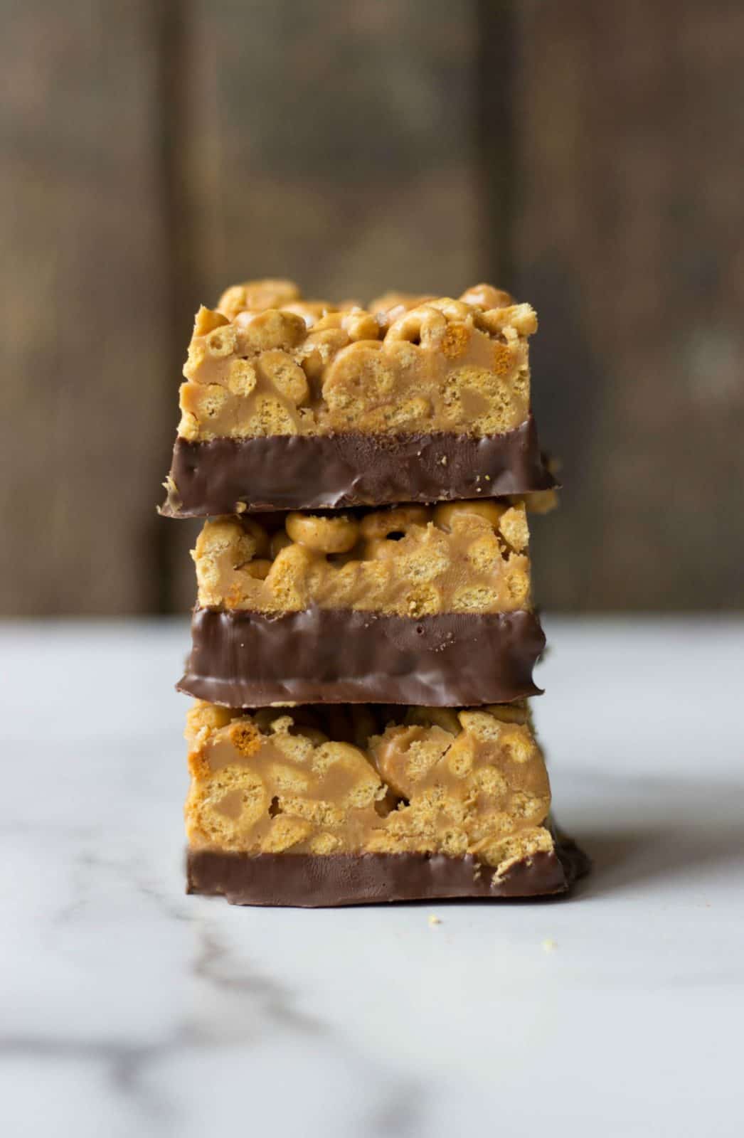Stack of three Chocolate-Dipped Peanut Butter Cereal Bars