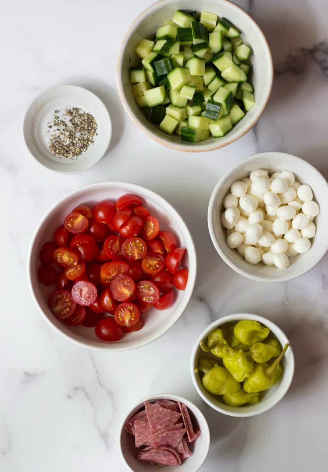 Italian Tortellini Salad Ingredients in white bowls