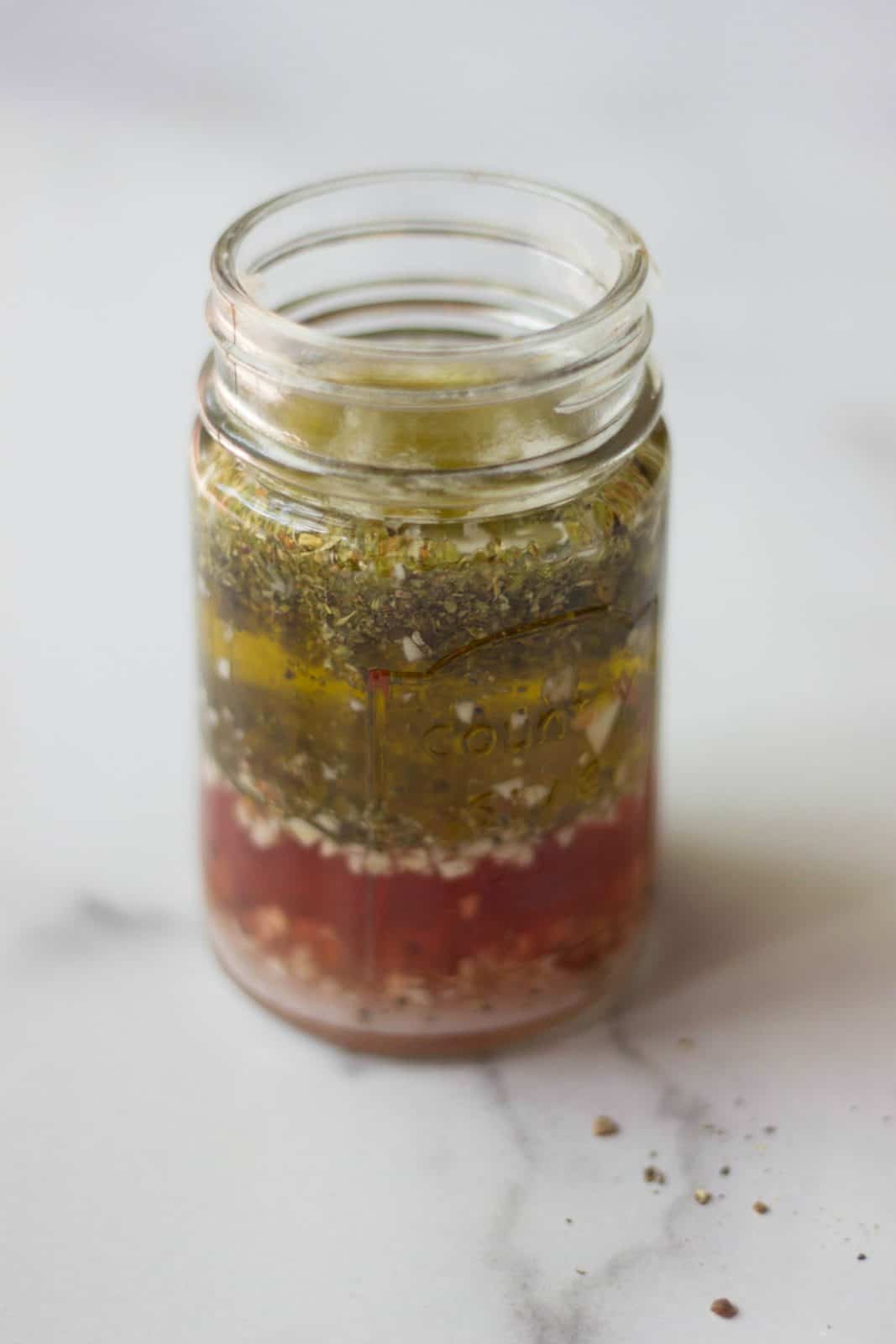 Italian Salad Dressing in a jar as an example of healthy fats in a balanced salad