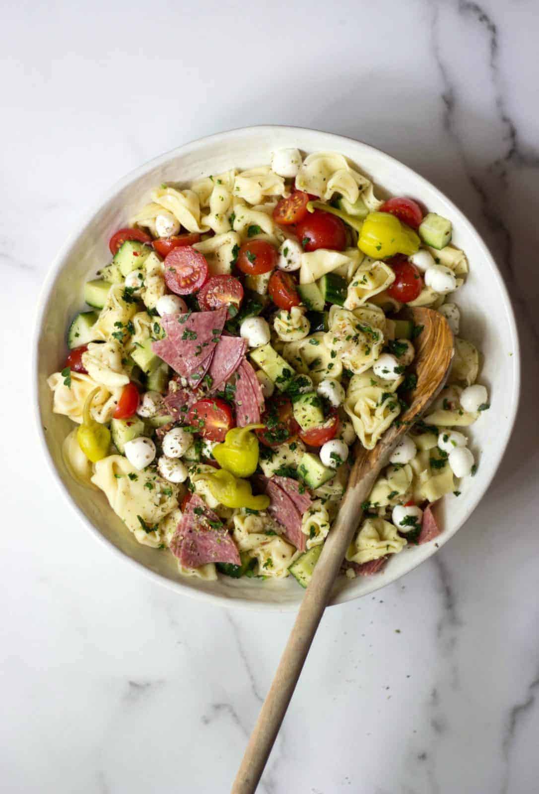 Overhead shot of Italian Tortellini Salad in a white bowl