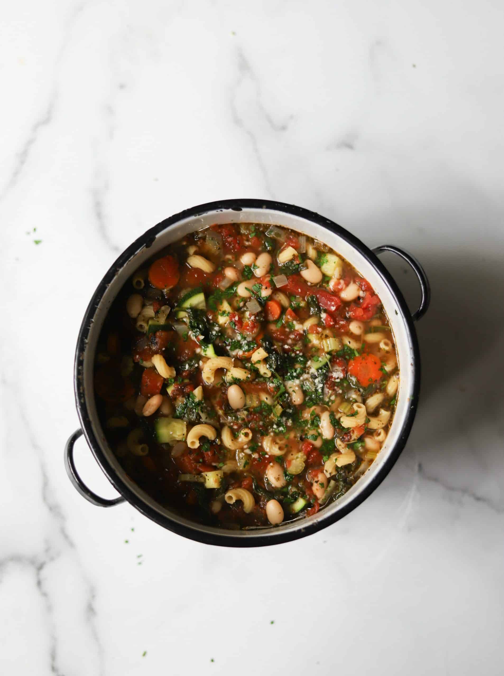 An overhead shot of a pot of vegetable minestrone.