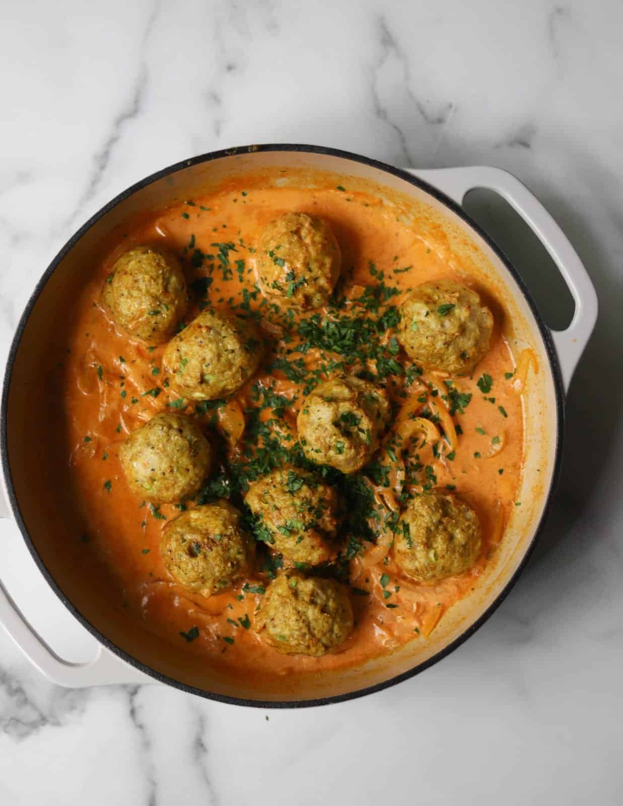 Curry Chicken Meatballs in a white dutch oven