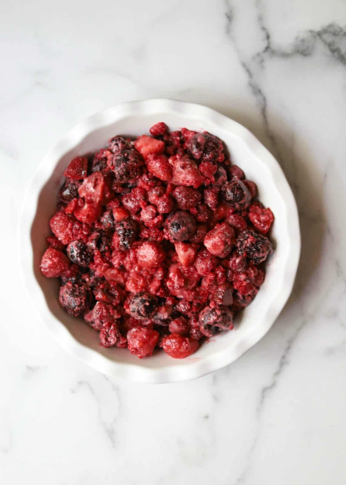 Mixed berry compote in a white pie dish