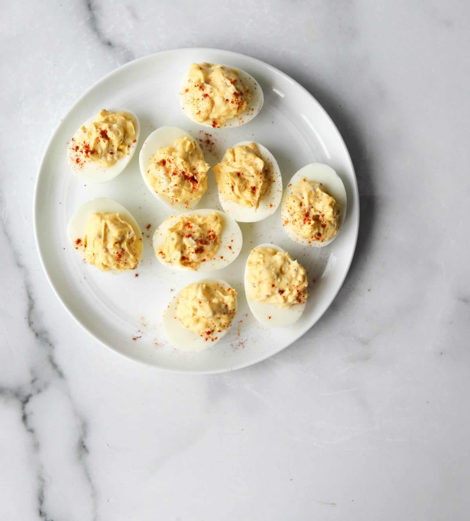 Deviled eggs on a white plate as an example of a healthy egg recipe