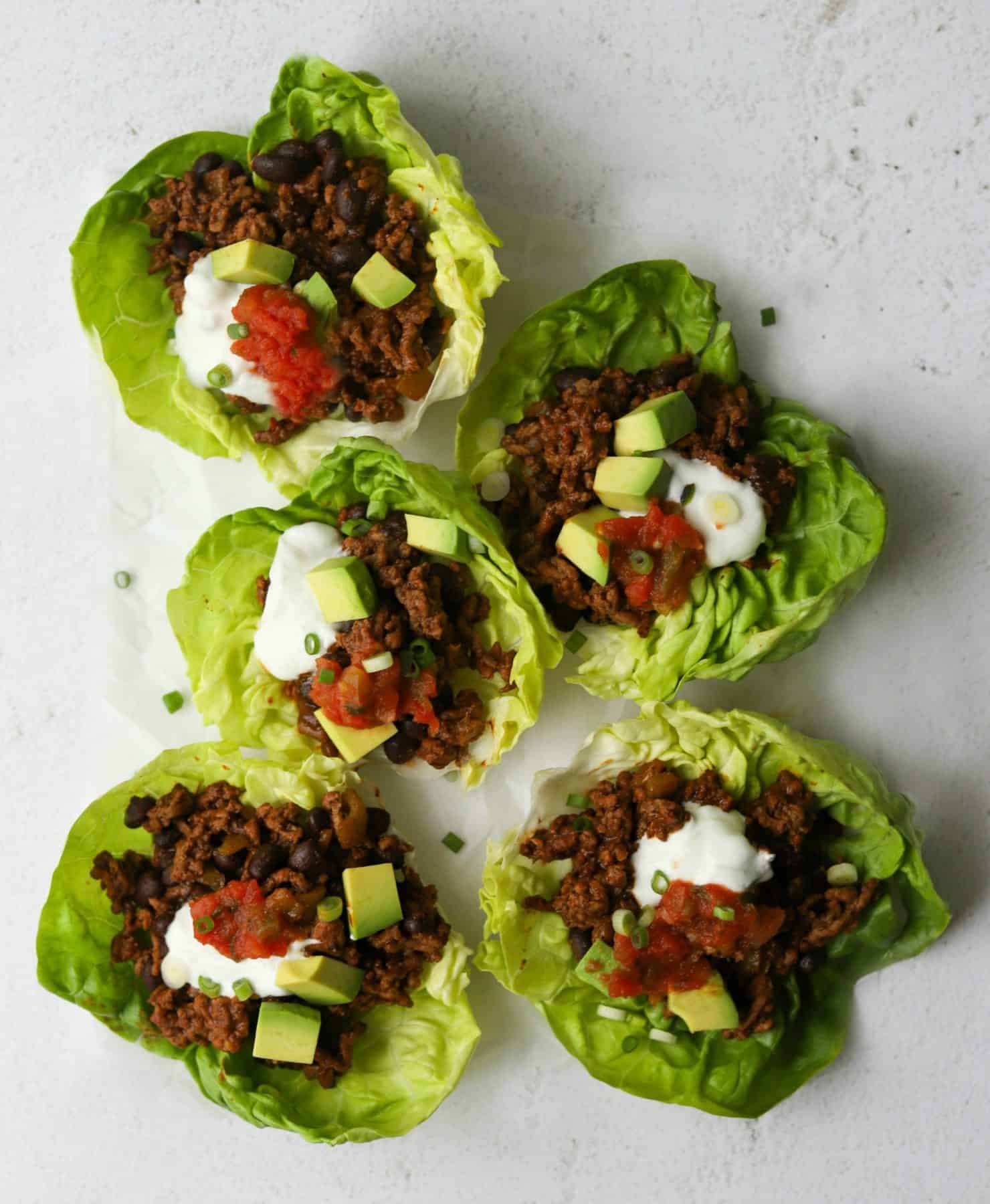 An overhead shot of taco lettuce cups on a platter.