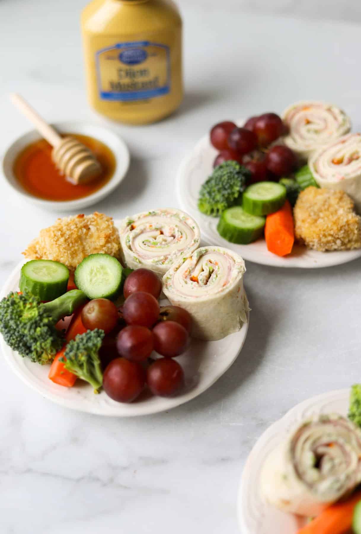 Mini snack plates on white marble backdrop (one of the back-to-school healthy recipes)