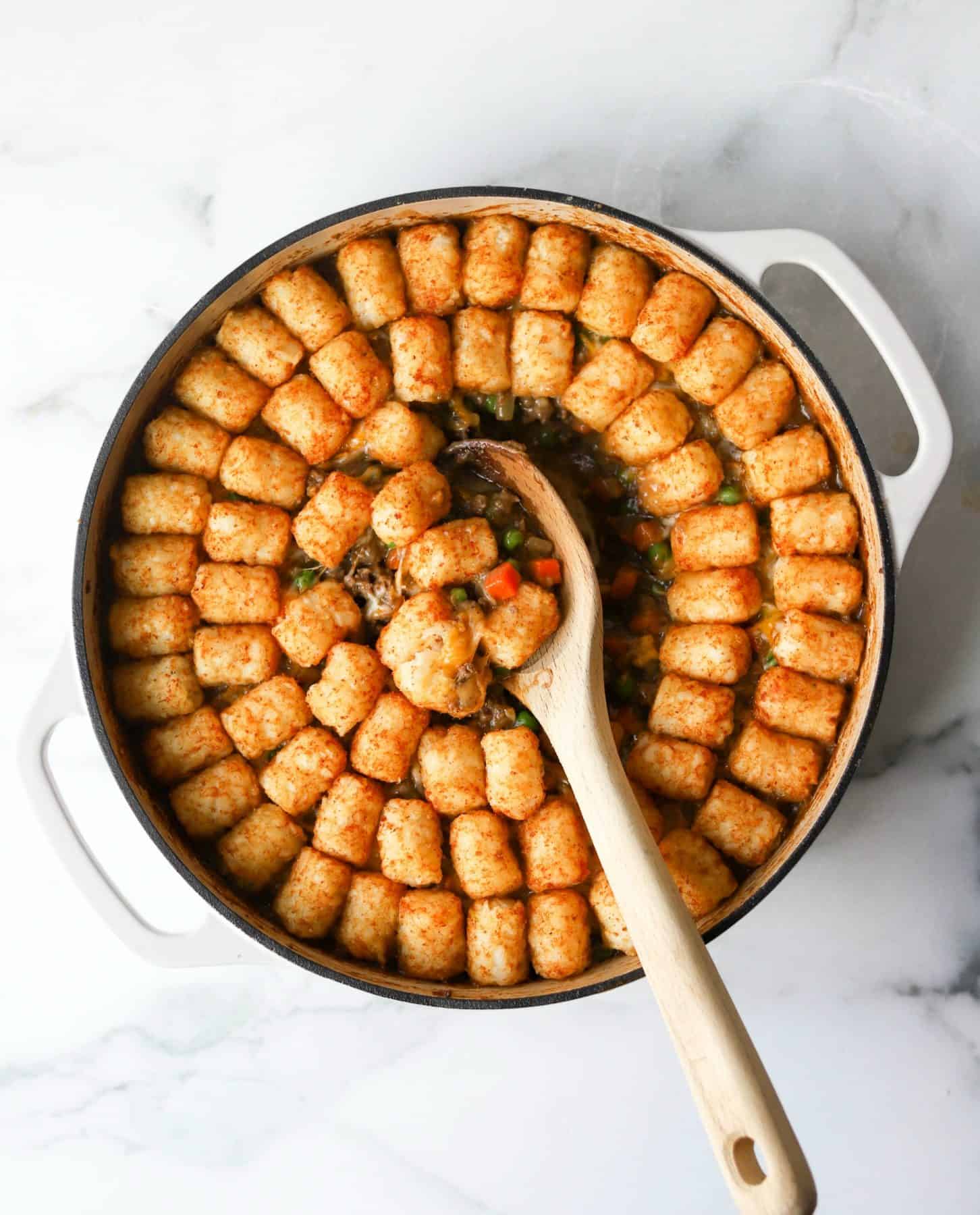Tater tot casserole in white dish (an example of a healthy one pot meal)